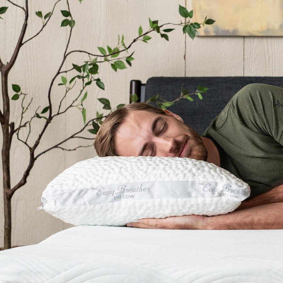 A side sleeper resting on the Nest Bedding Easy Breather Side Sleeper Pillow, the top pick in this guide