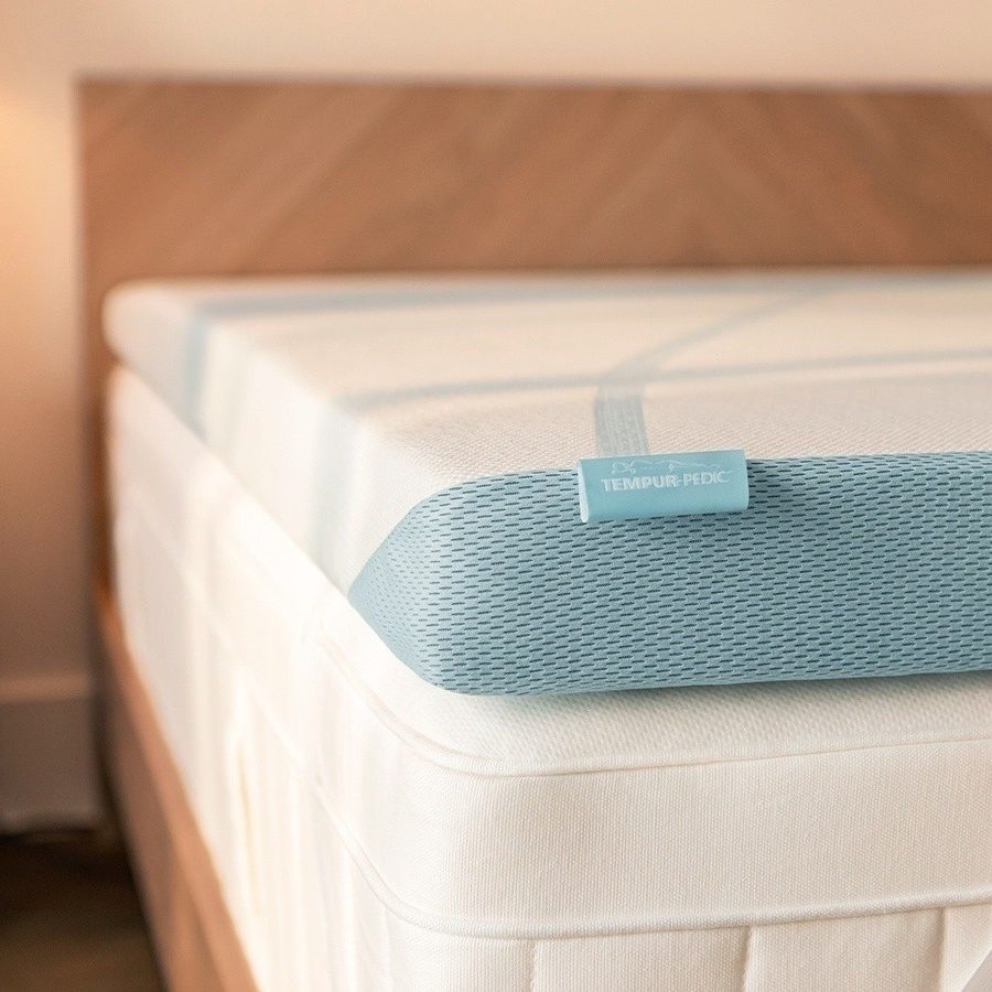Corner of a Tempur-Adapt + Cooling topper on a mattress, the top pick in this guide